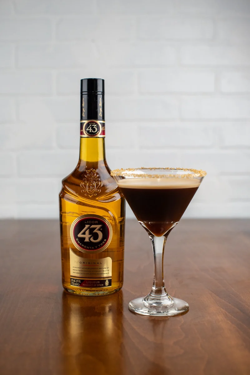 A Carajillo cocktail alongside a bottle of Licor 43