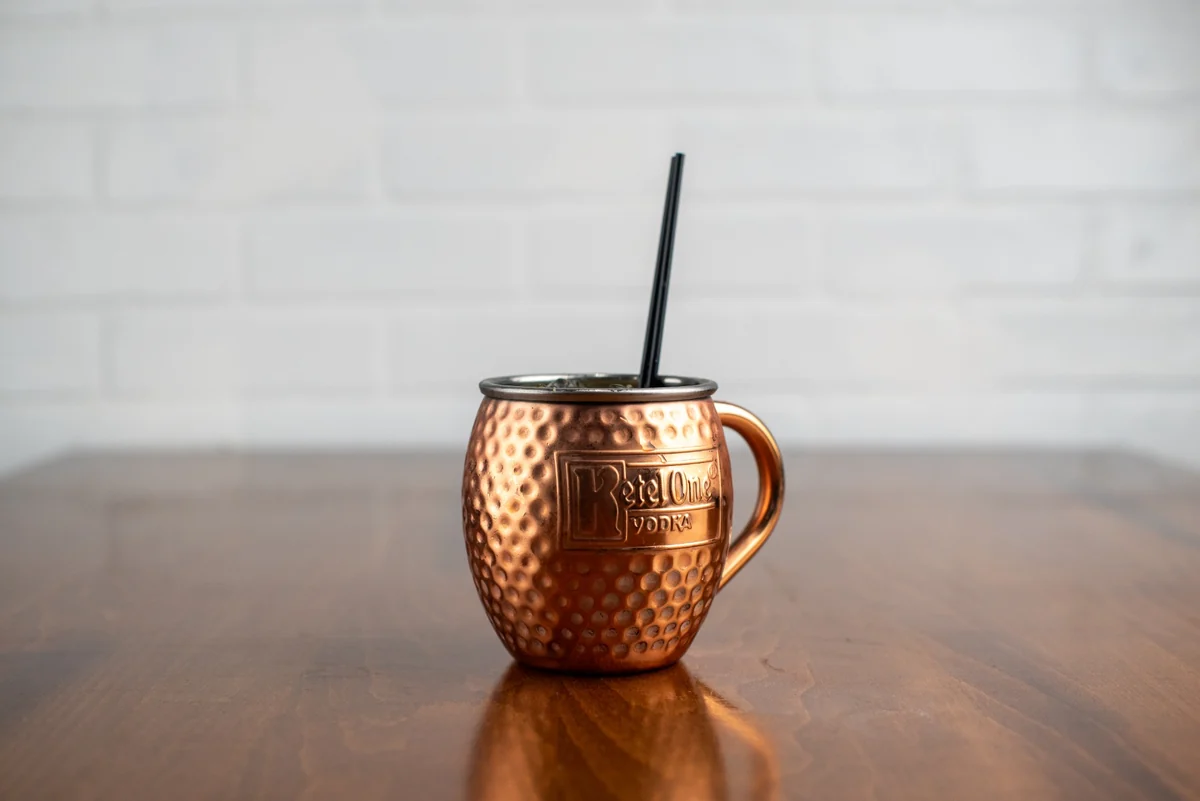 A Moscow Mule in a hammered copper mug on the Rewsters wood table