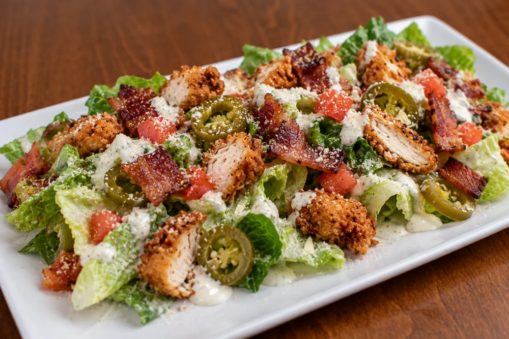 Chicken Bacon Ranch salad with crispy chicken, bacon, lettuce, tomato, and jalapenos