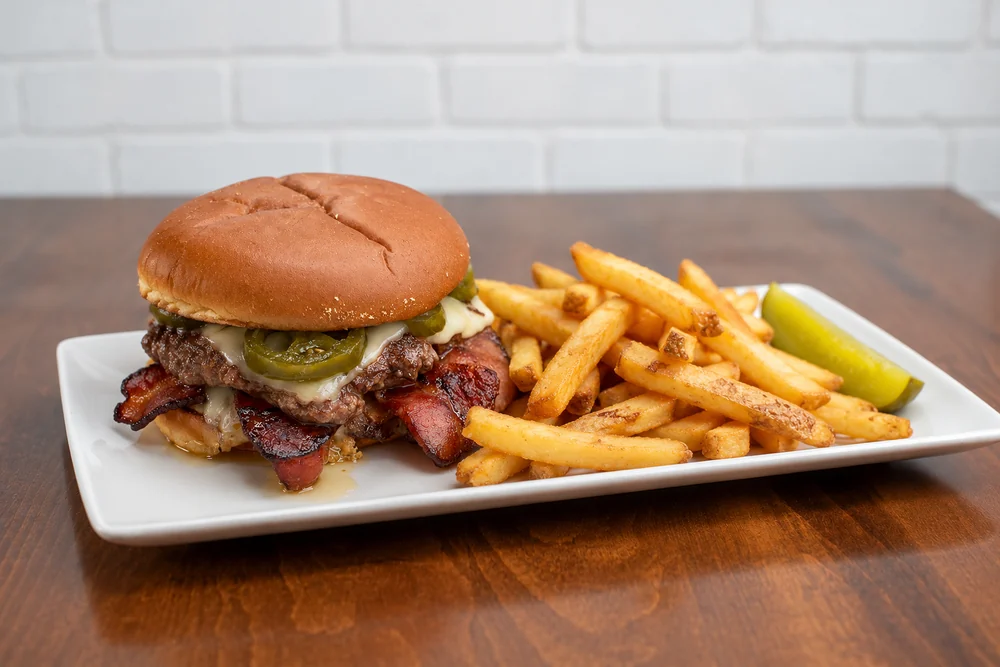 Hot Honey Smash with bacon, melted cheese, pickled jalapenos, and fries