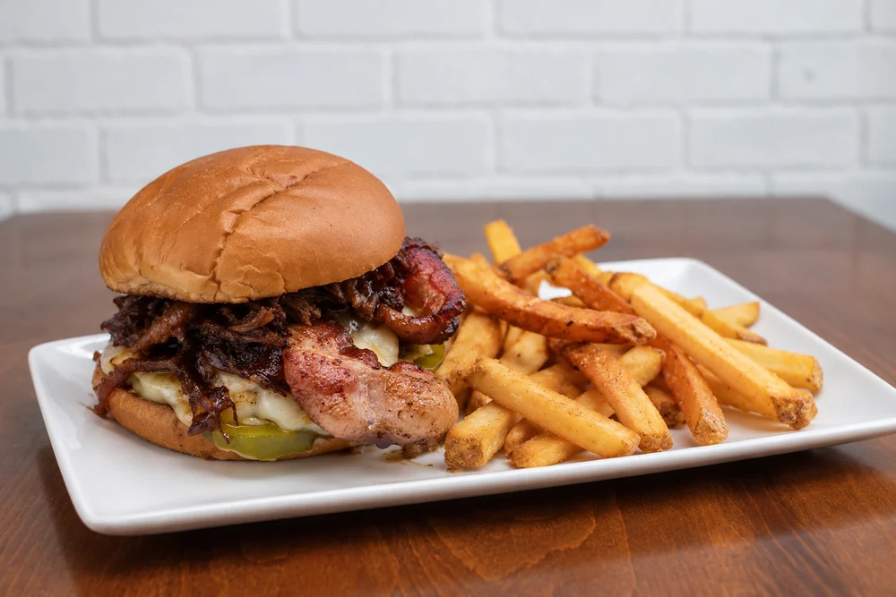 Rodeo Smash with braised beef, bacon, melted cheese, and fries