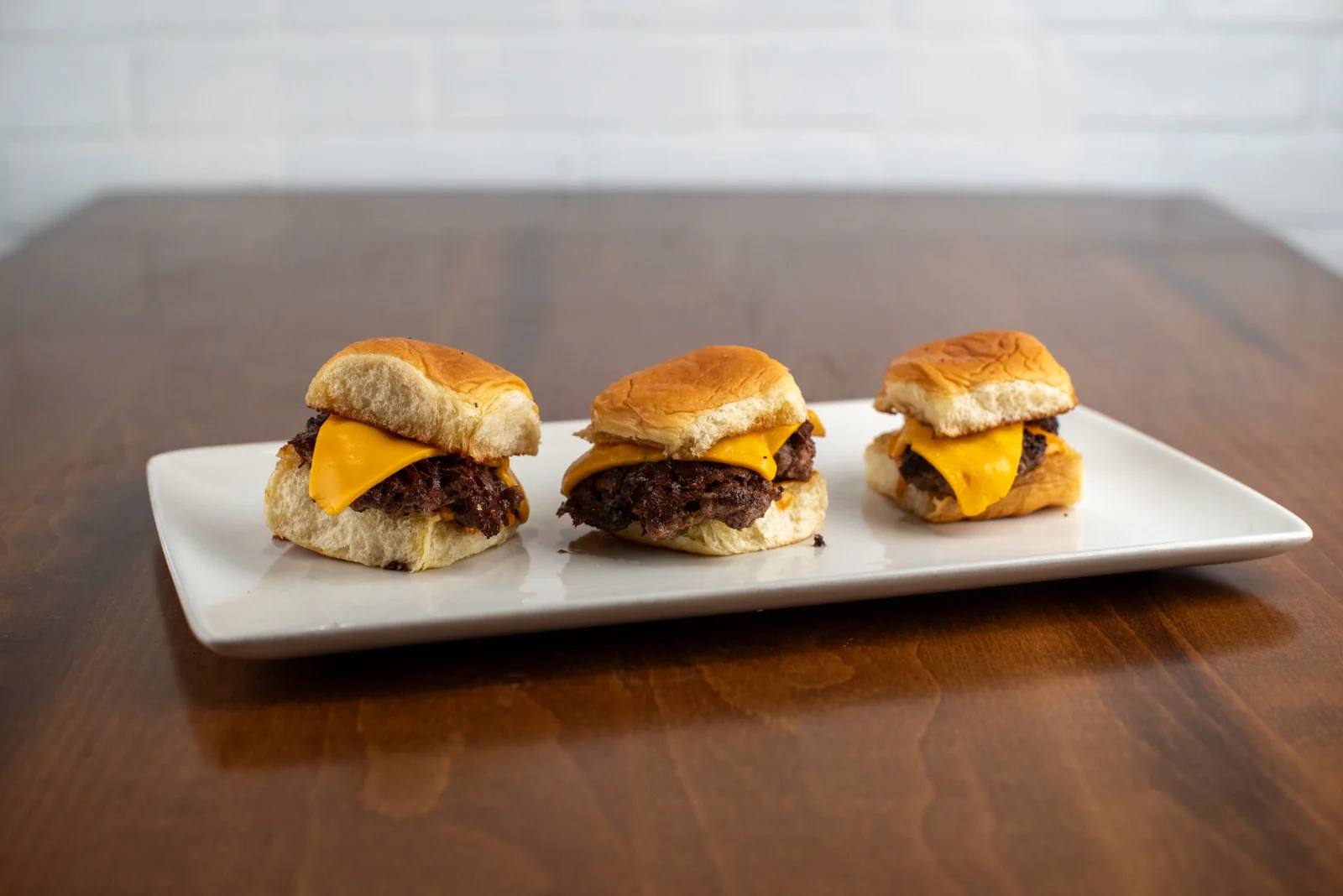 Three mini smash burgers served at Rewsters